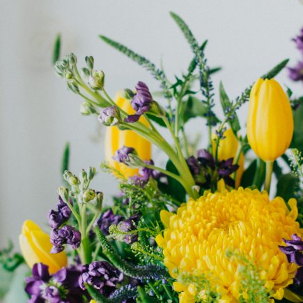 yellow and purple spring floral arrangement